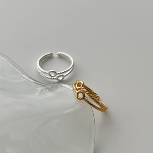 Dual layer twisted rope rings in silver and gold with an infinity double loop design