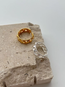 Detailed close-up of S925 silver rings with braided twist design in gold and silver finish