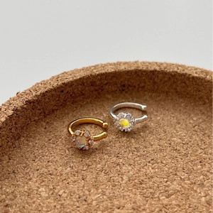 Elegant gold and silver ear clips set with micro-inlaid moonstones and floral details