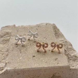 Luxury bow earrings in gold and silver finish with sparkling cubic zirconia crystals