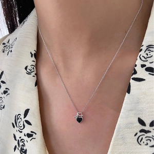 S925 sterling silver heart necklace with black agate and OT buckle worn by a model