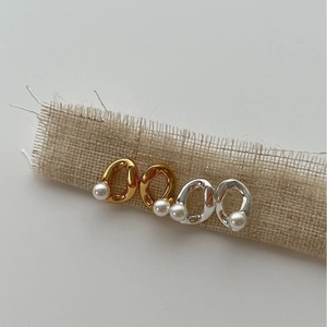 Minimalist S925 silver pearl earrings in gold and silver finishes on linen texture