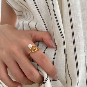925 Sterling Silver twist knot ring with pearl on finger, elegant adjustable open band