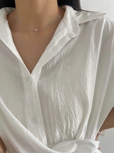 Minimalist S925 sterling silver heart necklace on model with elegant white shirt