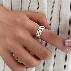 Minimalist S925 sterling silver hollow woven ring on finger for a stylish modern look
