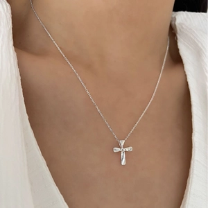 Classic S925 sterling silver cross necklace on female model with white blouse