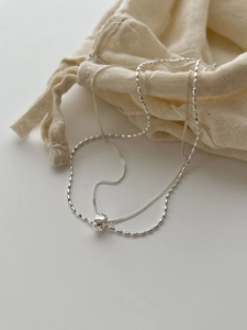 Close-up of S925 sterling silver double-layer necklace with cylindrical bead pendant