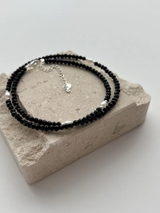 Detail of s925 silver beaded necklace featuring black agate and small white pearls