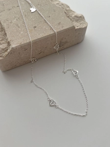 Detail of S925 sterling silver long necklace featuring delicate hollow heart-shaped links