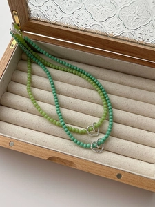 Detail of 925 sterling silver beaded necklaces with heart pendants in a wooden box
