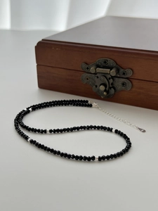 Close-up of S925 sterling silver clasp and faceted black spinel beads on necklace