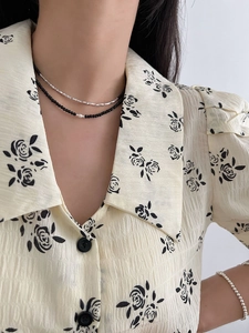 Close-up of double-layer S925 silver necklace with black spinel beads and white pearl detail