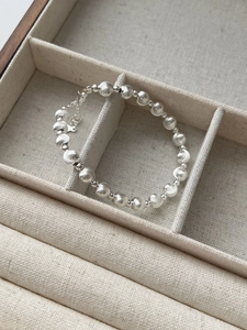 Detail of S925 silver bracelet featuring brushed beads, small stars and adjustable clasp
