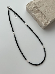 Detail of S925 sterling silver clasp and extender on a beaded black agate necklace