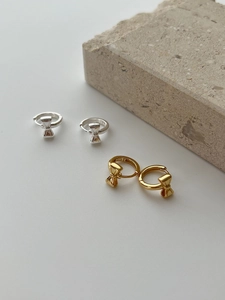 Detail showing S925 sterling silver bow earrings in gold and silver with hallmark