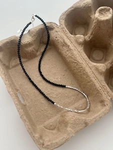 Close-up of S925 sterling silver clasp and black onyx beads on a unique beaded necklace