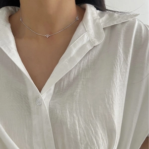 Minimalist S925 sterling silver necklace with three hollow heart pendants on a model