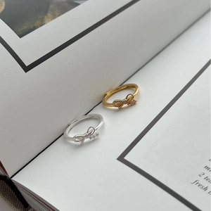 Silver and gold 925 sterling silver bow rings with sparkling cubic zirconia accents