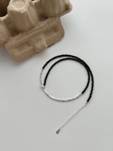 Close-up of S925 sterling silver stamp on black agate beaded necklace with lobster clasp
