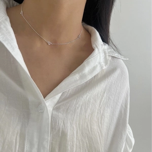 Minimalist S925 sterling silver collar necklace with multiple hollow heart pendants on a model