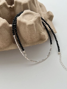 Detail of silver beads and black onyx stones necklace with adjustable lobster clasp
