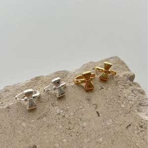 Elegant bow-shaped sterling silver stud earrings in gold and silver finish on stones