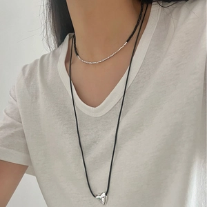 Layered silver bead necklace with black onyx accents and a minimalist heart pendant
