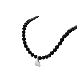Black beaded heart pendant necklace for women featuring polished beads and silver heart