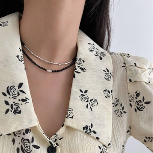 Double-layered S925 sterling silver necklace with black beads and a central pearl accent