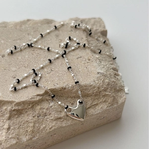 S925 sterling silver heart necklace with black beads on stone surface for women