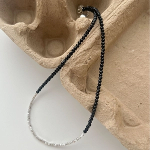 Minimalist beaded necklace featuring black onyx facets and irregular silver spacer beads