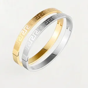 Minimalist gold and silver stainless steel bangles with Greek Greca pattern engraving