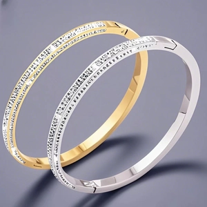 Detail of gold and silver stainless steel bangles with micro-pave cubic zirconia inlay