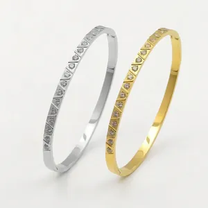 Elegant gold and silver stainless steel bangles with diagonal patterns and inlaid diamonds