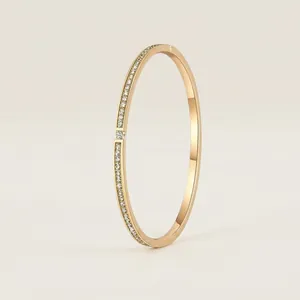 Elegant gold titanium steel bangle for women featuring star-dust pavé rhinestones