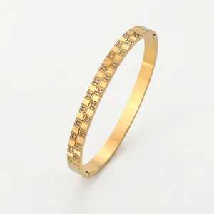 Golden stainless steel bangle with checkered pattern and inlaid zircon crystals