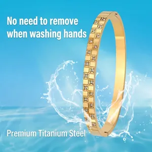 Golden titanium steel hinged bracelet with double row crystals and splash effect