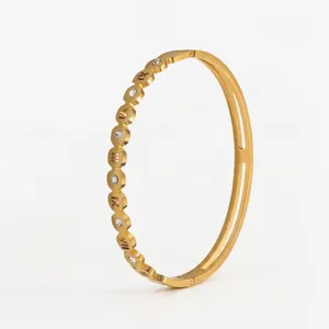 Gold plated stainless steel bangle with Roman numerals and sparkling cubic zirconia crystals