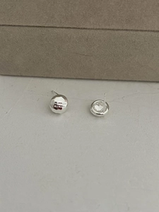 Detailed macro view of S925 sterling silver earrings with textured hammered finish design