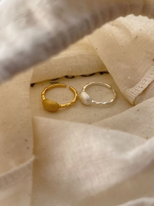Detailed macro view of S925 sterling silver stamp on textured lava adjustable rings