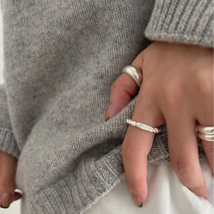 Three-piece stackable 925 sterling silver ring set featuring twist knot and smooth bands
