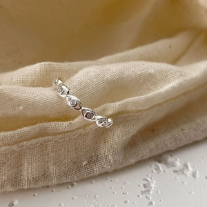 Minimalist S925 sterling silver open ring with marquise cut stones on a linen surface
