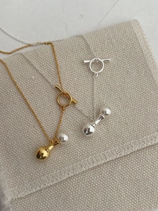 Detail of s925 silver perfume bottle pendant with pearl and T-clasp toggle closure