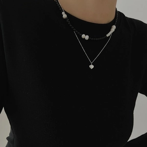 Double-layered 925 silver necklace with black beads, pearls and heart pendant on model