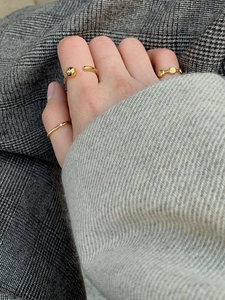 Close-up of a minimalist 925 sterling silver gold-plated ring set on a model's hand