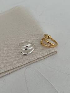 Close-up of minimalist S925 sterling silver layered rings with liquid metal water drop design