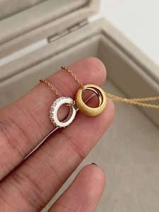 Macro detail of two-tone 925 silver round pendants with rhinestones and matte finish
