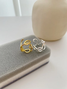 Close-up of S925 sterling silver hallmark on irregular open rings in gold and silver