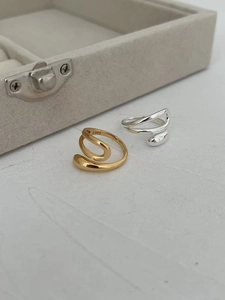 Macro detail of gold and silver S925 sterling silver rings with liquid metal texture
