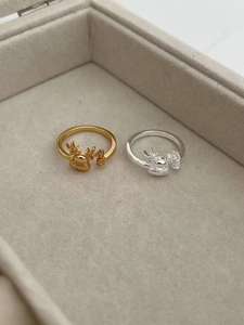 Detail of silver and gold reindeer rings with S925 engraving in a velvet jewelry box